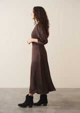 Woman wearing dark brown leopard print  satin dress