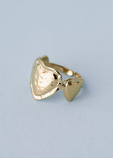 Gold hammered heart ring on blue background