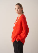 Woman wearing bright red mohair blend cardigan