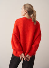 Woman wearing bright red mohair blend cardigan