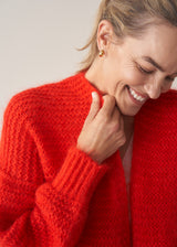 Woman wearing bright red mohair blend cardigan