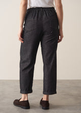 Woman wearing blue black straight leg denim jeans