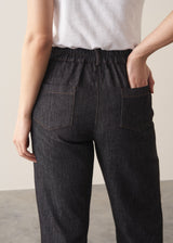 Woman wearing blue black straight leg denim jeans