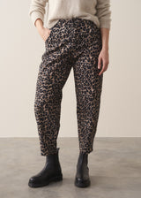 Woman wearing oatmeal mohair jumper and leopard print barrel leg jeans black boots