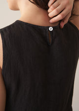 Woman wearing black linen cocoon dress