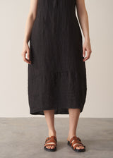 Woman wearing black linen cocoon dress