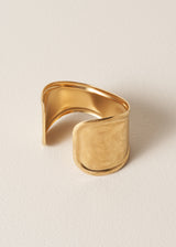 Gold cuff bracelet on a beige background