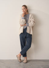 Woman wearing dark blue-grey cotton joggers and navy and cream stripe top