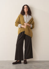 Model wearing pale checked shirt and brown corduroy trousers