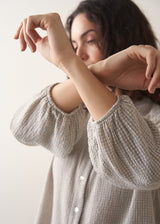Model wearing pale checked shirt and brown corduroy trousers