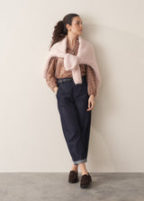 Woman wearing brown floral print top with dark blue jeans