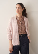 Woman wearing brown floral print top with dark blue jeans