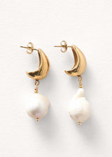 Large pearl drop earrings on white background
