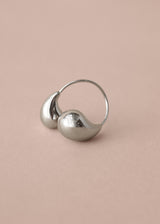 Chunky silver twist ring on a beige background