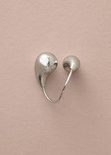 Chunky silver twisted ring on beige background