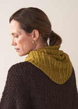 Back of woman wearing a olive knitted neckscarf with brown jumper