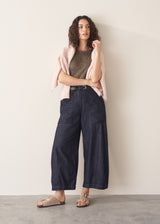 Woman wearing khaki stripe t-shirt and blue wide leg jeans
