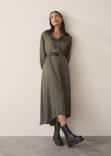 Woman wearing a long dark green satin dress 