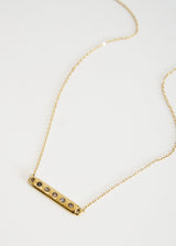 Gold necklace with bar and grey crystals